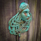 Art Nouveau inspired sculpture of beautiful female face with long stylised hair