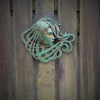 Art Nouveau inspired sculpture of beautiful female face with long stylised hair